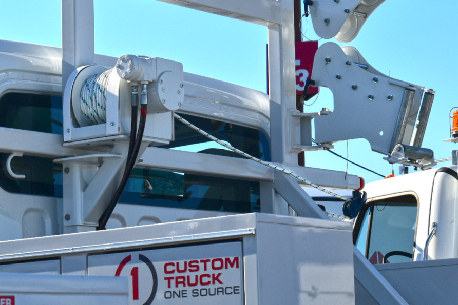 close-up of a custom truck with hydraulic lift and safety equipment against a clear blue sky