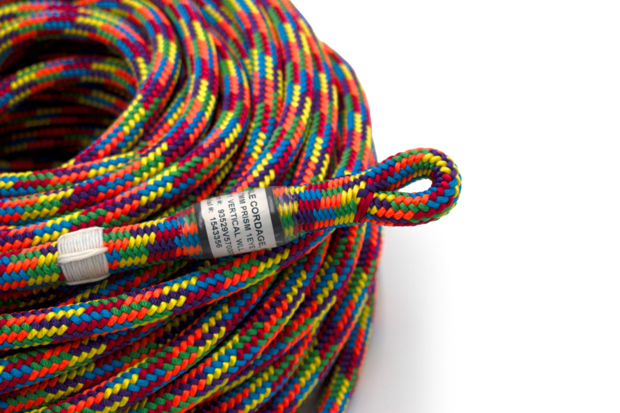 Colorful coiled climbing rope with a visible loop and safety label.