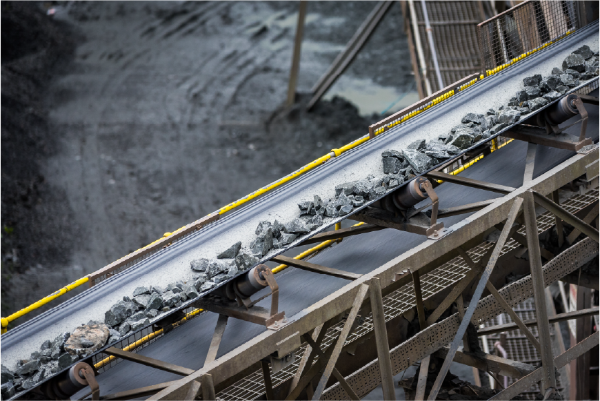 Conveyor belt transporting rocks in a quarry.